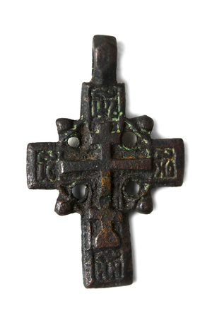 ancient cross on the neck isolated on white backgroundの写真素材