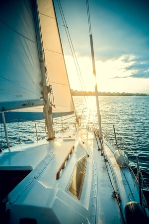 Yacht on the water at sunset, dawn with filterの写真素材