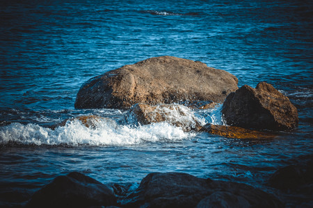 Big stones on the beach sea on a sunny day, filterの写真素材