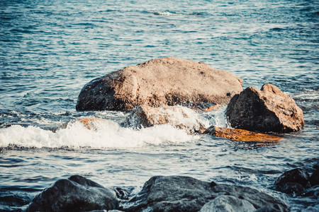 Big stones on the beach sea on a sunny day, filterの写真素材