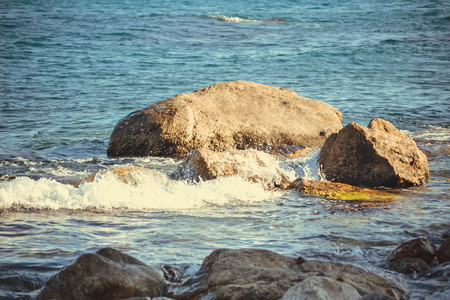 Big stones on the beach sea on a sunny day, filterの写真素材