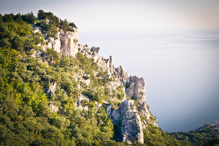 sharp tip of a cliff with trees and sea, Crimea, Southern Coastの写真素材