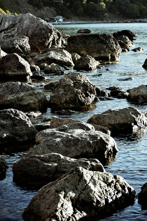 stones in the water near the shore, filterの写真素材