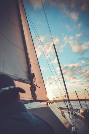 yacht at sunset and diffuse back manの写真素材