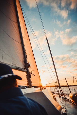 yacht at sunset and diffuse back manの写真素材