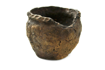 Old clay pot on a white background close-upの写真素材