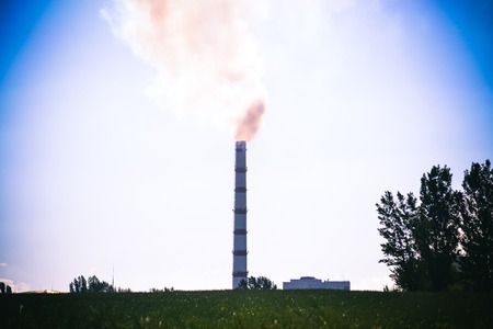 Pipe factory smoke in the field with clear sky, filter