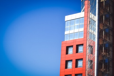 facade, front of the large house red and gray in the high-tech style on a bright sunny day on blue sky backgroundの写真素材