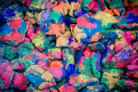 abstract background of the plane lying on colored stones close-up,. Many stones painted with colored inksの写真素材