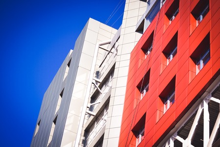 facade, front of the large house red and gray in the high-tech style on a bright sunny day on blue sky backgroundの写真素材