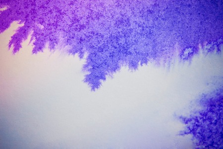 Blue and pink ink on white paper conveyed over close-up. Figure drawing resembles frost on the window, snowflakeの写真素材
