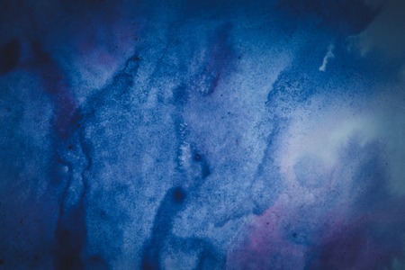 ink spot spreads on paper blue colorの写真素材