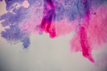 ink spot spreads on paper purple and pink colorの写真素材