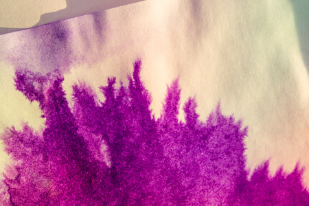 ink spot spreads on paper purple and pink colorの写真素材