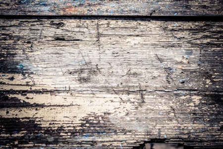 old shabby wooden surface close up with cracked paintの写真素材