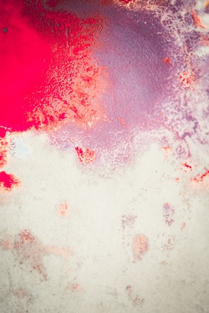 Abstract background of blots pink, red and maroon color with streaks and splashes on white paper