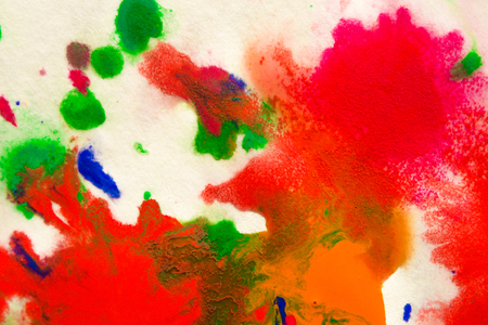 abstract spots splash of bright red, green, blue colors on white paper macroの写真素材