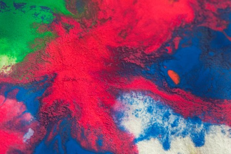 abstract spots splash of bright red, green, blue colors on white paper macroの写真素材