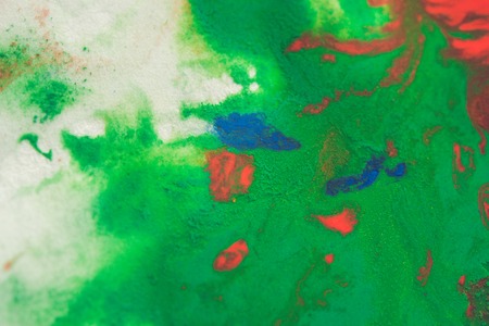 abstract spots splash of bright red, green, blue colors on white paper macroの写真素材