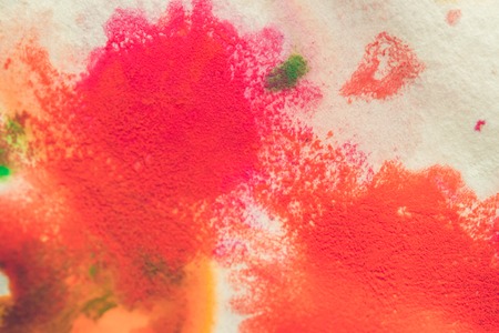 abstract spots splash of bright red, green, blue colors on white paper macroの写真素材