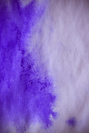 Purple ink stain on a sheet of white paper macro. Abstract background. Spreads ink stains with streaks on a white background. Absorb close-upの写真素材