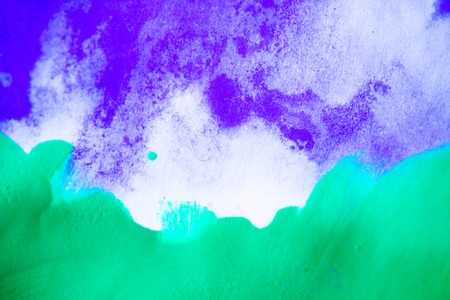 bright purple ink streaks and green strokes paint on a white backgroundの写真素材