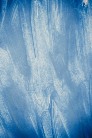 uncertain chaotic backdrop. strokes of blue paint made by a finger. blue finger smears on a white background. abstract background space for text baseの写真素材
