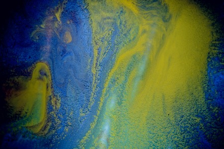 bursts of multicolored paints and mixed together white paper. Drawn splashes of paints of different colors on white surface. Blue, yellow, red, green color. Spreading spraying flow leak stream mixingの写真素材