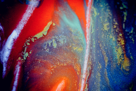 bursts of multicolored paints and mixed together white paper. Drawn splashes of paints of different colors on white surface. Blue, yellow, red, green color. Spreading spraying flow leak stream mixingの写真素材