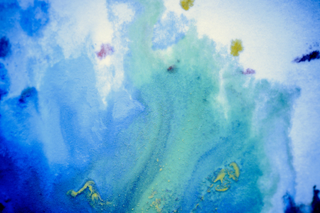 bursts of multicolored paints and mixed together white paper. Drawn splashes of paints of different colors on white surface. Blue, yellow, red, green color. Spreading spraying flow leak stream mixingの写真素材