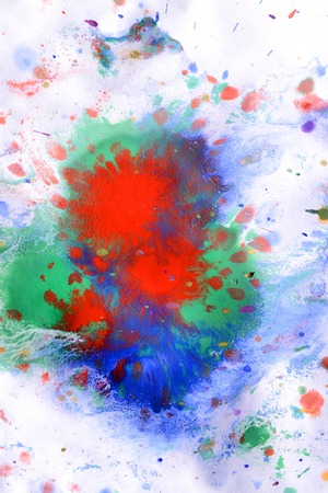explosive emotional drops of bright red, green, blue on white paperの写真素材