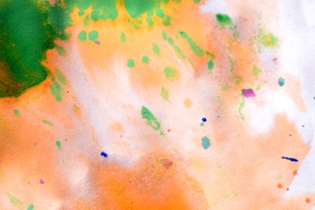 Warm abstract background red, yellow, orange ink spot swith green drops on white paperの写真素材