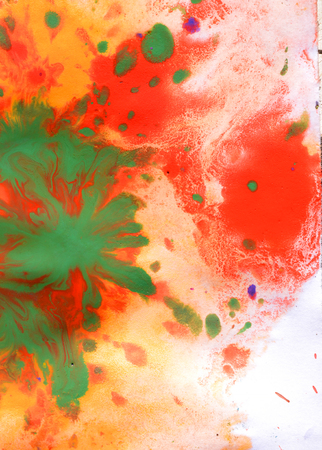 Warm abstract background red, yellow, orange ink spot swith green drops on white paperの写真素材