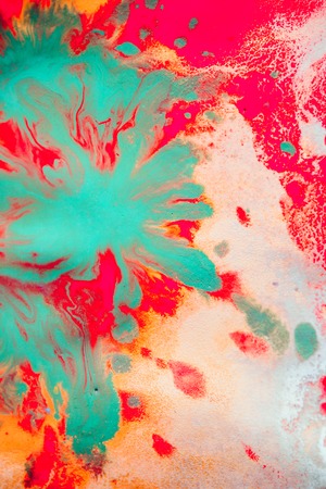 Warm abstract background red, yellow, orange ink spot swith green drops on white paperの写真素材