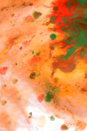 Warm abstract background red, yellow, orange ink spot swith green drops on white paperの写真素材
