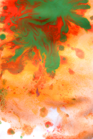 Warm abstract background red, yellow, orange ink spot swith green drops on white paperの写真素材