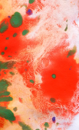 Warm abstract background red, yellow, orange ink spot swith green drops on white paperの写真素材
