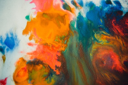 Whirlwind vortex spreads colored ink colors on white background. Abstractly spreads dye ink red, green, yellow, orange, blue background on paper. Art Creative abstract background. Colorful backgroundの写真素材