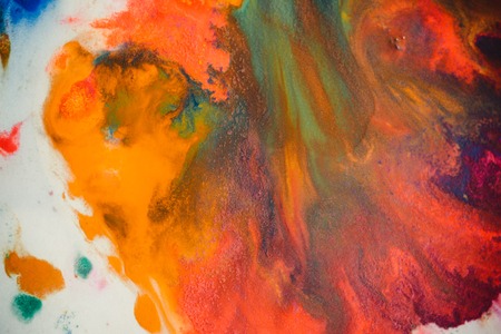 Whirlwind vortex spreads colored ink colors on white background. Abstractly spreads dye ink red, green, yellow, orange, blue background on paper. Art Creative abstract background. Colorful backgroundの写真素材