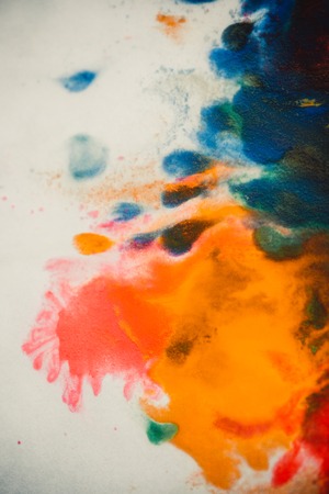 Whirlwind vortex spreads colored ink colors on white background. Abstractly spreads dye ink red, green, yellow, orange, blue background on paper. Art Creative abstract background. Colorful backgroundの写真素材