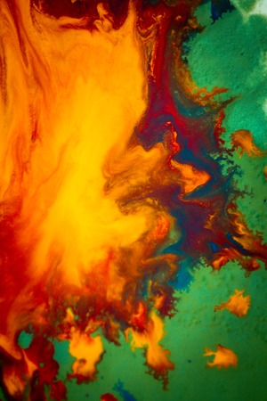 Whirlwind vortex spreads colored ink colors on white background. Abstractly spreads dye ink red, green, yellow, orange, blue background on paper. Art Creative abstract background. Colorful backgroundの写真素材