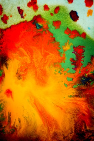 Whirlwind vortex spreads colored ink colors on white background. Abstractly spreads dye ink red, green, yellow, orange, blue background on paper. Art Creative abstract background. Colorful backgroundの写真素材