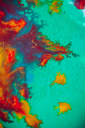 spreads colored ink colors on white background. Abstractly spreads dye ink red, green, yellow, orange, blue background on paper. Art Creative abstract background. Colorful backgroundの写真素材