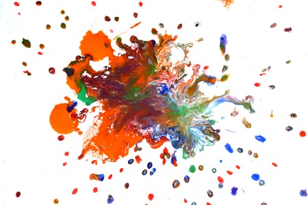Isolated large patches spots blots of splash of mixed colors on a white background. Divorces and paint drips red, orange, yellow, blue blurred abstract background on a white paper background surfaceの写真素材