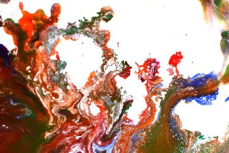 Isolated large patches spots blots of splash of mixed colors on a white background. Divorces and paint drips red, orange, yellow, blue blurred abstract background on a white paper background surfaceの写真素材