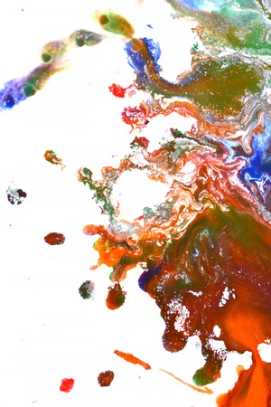 Isolated large patches spots blots of splash of mixed colors on a white background. Divorces and paint drips red, orange, yellow, blue blurred abstract background on a white paper background surfaceの写真素材