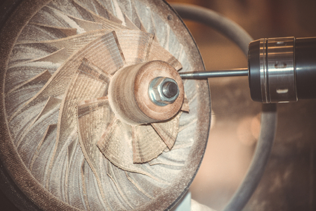 Five-axis machine for the processing of basic parts at high speeds during milling. The machine for the treatment of avia, air turbine closeup. Milling machine carves turbine blades close-upの写真素材