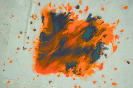 overflowing bright orange and dark blue paint on paper. Shabby style abstract faded background. Mixing paints close-up. Abstract base backdrop abstract background backdrop framework for creativity artの写真素材