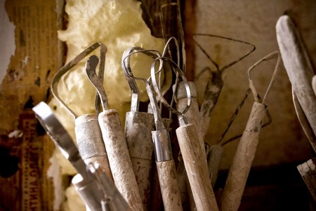 tools for modeling in clay are in a glass closeup. Creative studio potter. Workplace wizard Crock potteryの写真素材