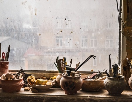 windowsill on which stand in vases tools in potteryの写真素材